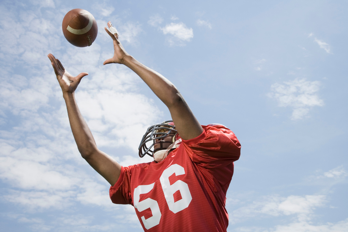 Football player catching ball